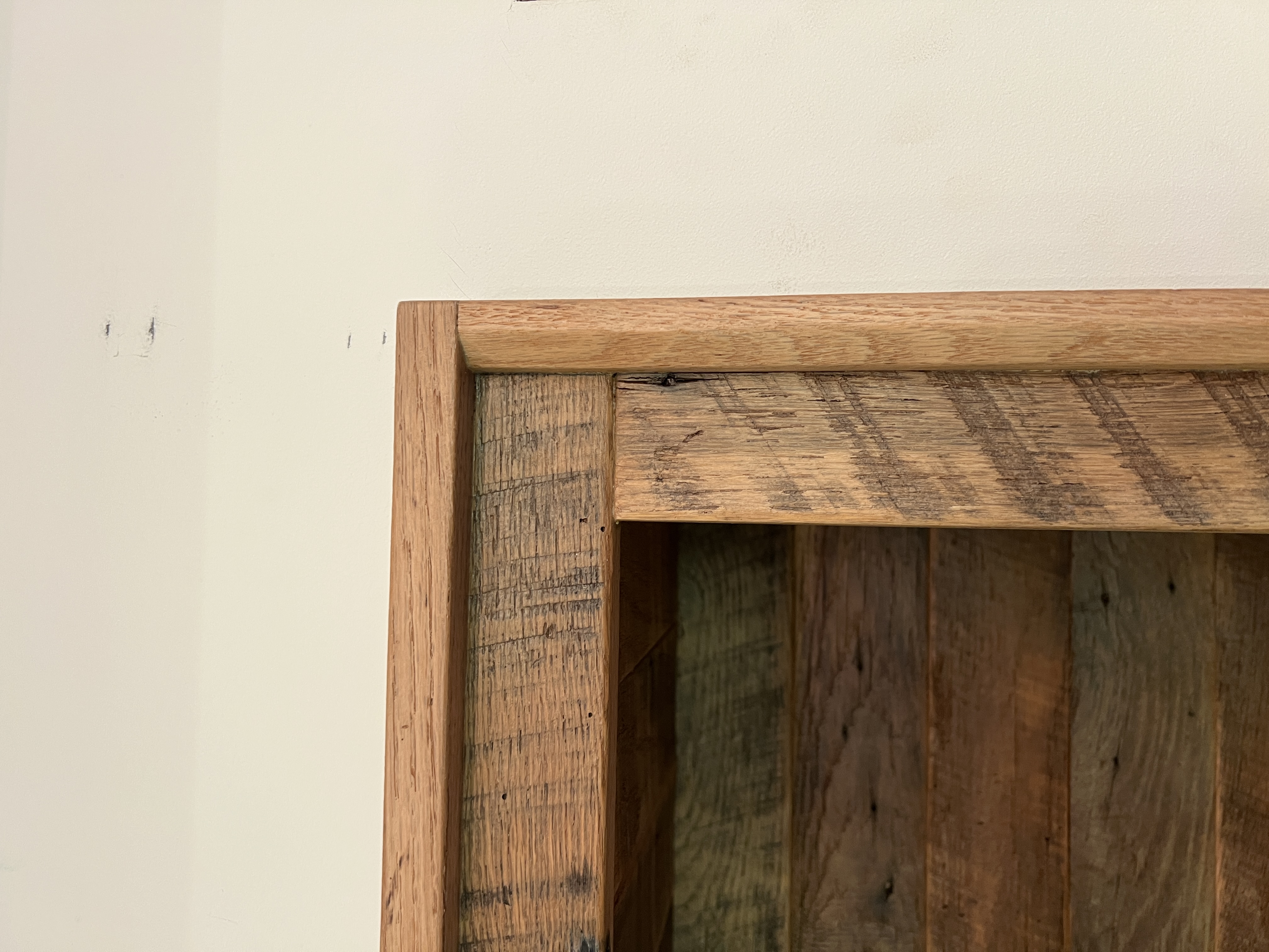 Close-up of reclaimed wood bookshelf corner joinery detail